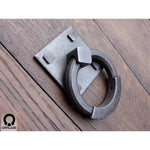 wrought iron ring pull with square backplate attached to a wooden door made by gaaluub